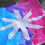 A simple craft to make with your toddler this winter are these snowflake paintings with masking tape.