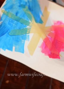 A simple craft to make with your toddler this winter are these snowflake paintings with masking tape.