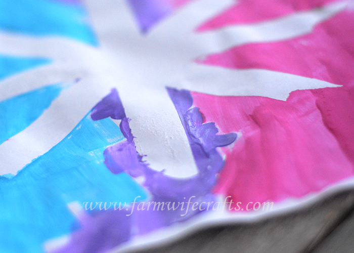 A simple craft to make with your toddler this winter are these snowflake paintings with masking tape.