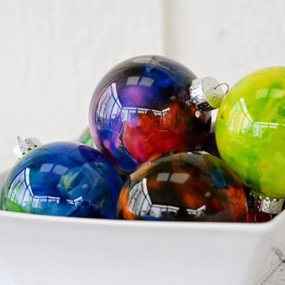 Do you have any holiday traditions?  We have a few and one of them is that the girls make a new ornament every year like these Melted Crayon Ornaments.