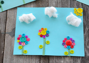 Who's ready for spring flowers, sunshine, and blue skies??? I definitely am. This button flower craft definitely brightens up my home and adds a smile to my face when I look at it.