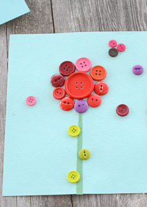 Who's ready for spring flowers, sunshine, and blue skies??? I definitely am. This button flower craft definitely brightens up my home and adds a smile to my face when I look at it.