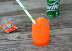 It's heating up this Summer and your kiddos will love this fun treat!  No need to head to the gas station because you can make and even better slushie right at home.  This 3 Ingredient Kool-Aid Slushie will be your kid's new favorite Summer treat!