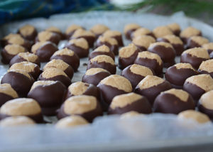 Buckeyes.  They're a Christmas favorite and one of the most popular holiday foods to make and share with friends and family.  They are so easy to make and so yummy.  You will have a hard time giving them away because they are so good!