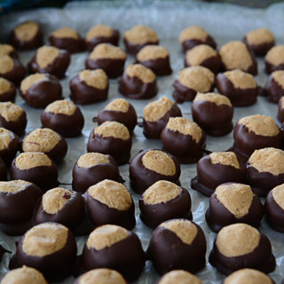 Buckeyes. They're a Christmas favorite and one of the most popular holiday foods to make and share with friends and family. They are so easy to make and so yummy. You will have a hard time giving them away because they are so good!
