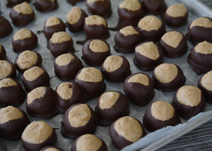 Buckeyes.  They're a Christmas favorite and one of the most popular holiday foods to make and share with friends and family.  They are so easy to make and so yummy.  You will have a hard time giving them away because they are so good!