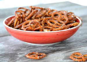Are you looking to spice up those boring pretzels to serve at your next get-together?  These Seasoned Pretzels are easy to whip up with only a few ingredients and are a definite crowd pleaser!