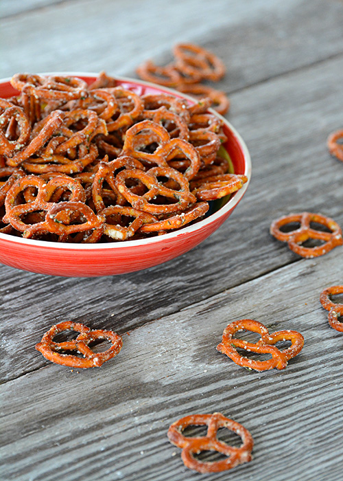 Are you looking to spice up those boring pretzels to serve at your next get-together?  These Seasoned Pretzels are easy to whip up with only a few ingredients and are a definite crowd pleaser!