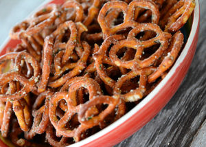 Are you looking to spice up those boring pretzels to serve at your next get-together?  These Seasoned Pretzels are easy to whip up with only a few ingredients and are a definite crowd pleaser!