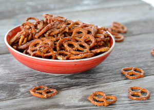 Are you looking to spice up those boring pretzels to serve at your next get-together?  These Seasoned Pretzels are easy to whip up with only a few ingredients and are a definite crowd pleaser!