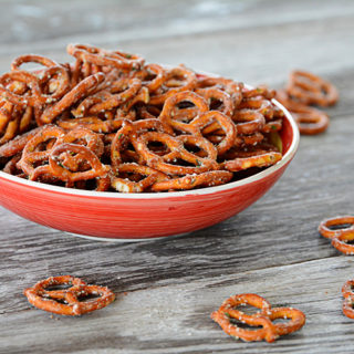 Are you looking to spice up those boring pretzels to serve at your next get-together?  These Seasoned Pretzels are easy to whip up with only a few ingredients and are a definite crowd pleaser!
